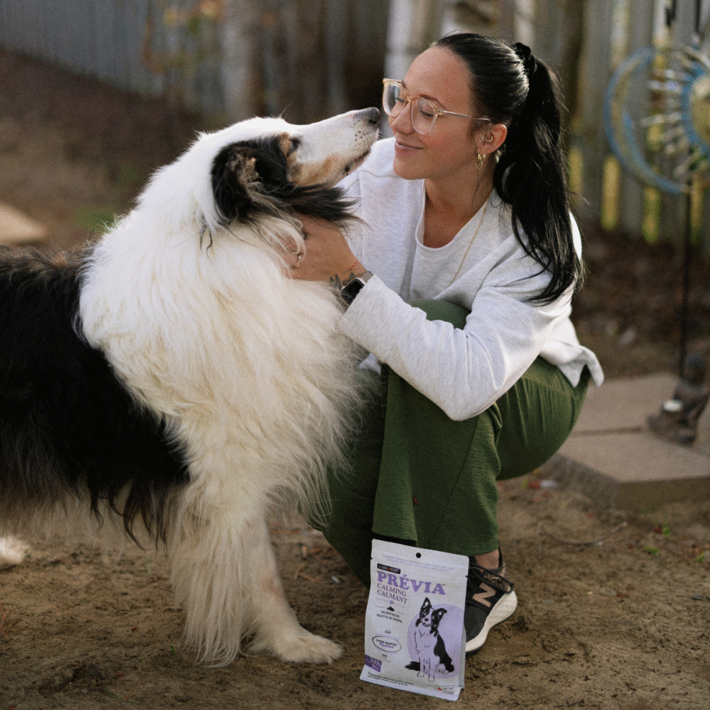 Woman reunited with her dog after work and playing outdoors with Prévia Calmant functional dog treats